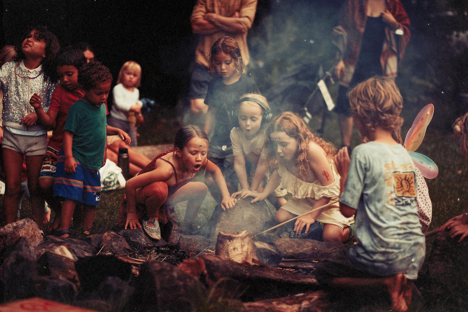 Children gathered around a campfire at the festival