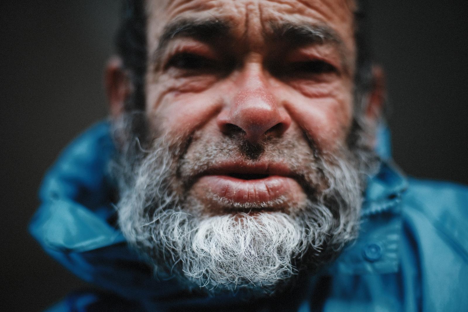 Straight-on close portrait of the man's face, looking at the camera